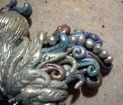 clay-fantasy-bird-swirls-wing-close-up