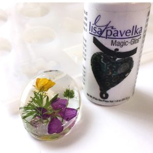 dried flowers in an oval UV resin pendant shape