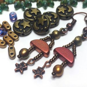 Seed beads from the January 2020 Potomac bead box, including two-hole semi circle beads, a star charm, moon and stars metal beads and earrings made with these beads.